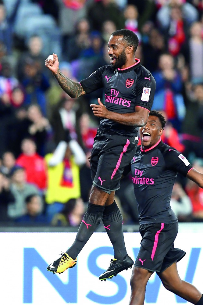 Arsenal player Alexandre Lacazette (left) celebrates after scoring his first goal for Arsenal in his first match during their football friendly against Sydney FC played in Sydney.