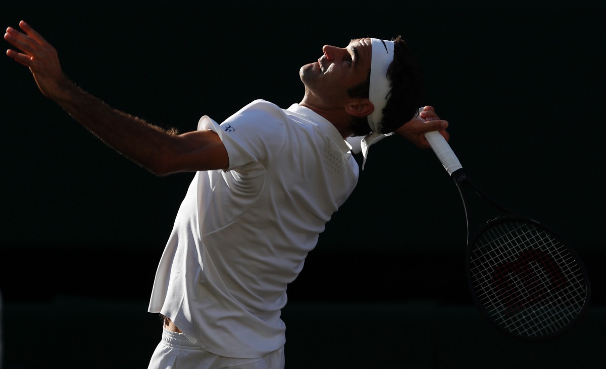 Switzerland's Roger Federer serves to Czech Republic's Tomas Berdych during their men's singles semi-final match on the eleventh day of the 2017 Wimbledon Championships at The All England Lawn Tennis Club in Wimbledon, southwest London, on July 14, 2017. 