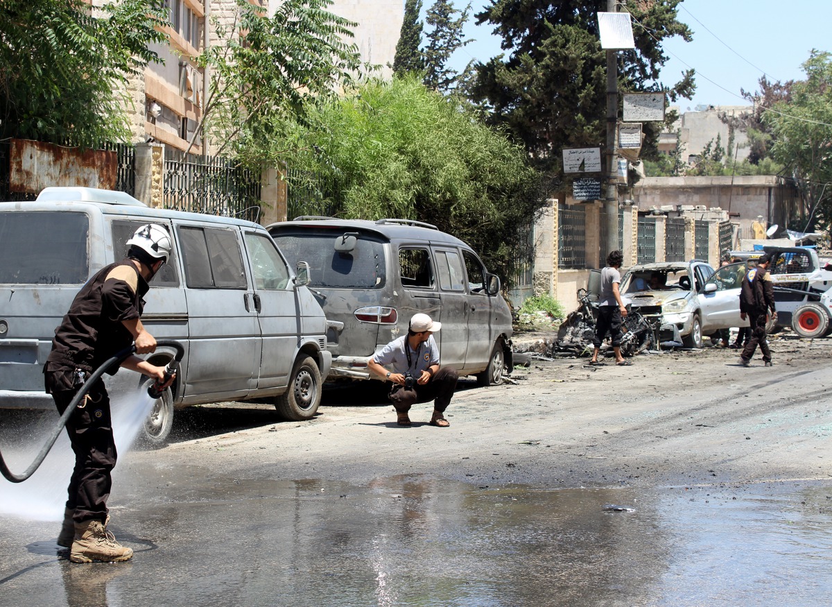 People inspect the site after an attack with a bomb-laden vehicle near the Al Majd hospital in Idlib, Syria on July 16, 2017. (Ahmed Momar - Anadolu Agency)