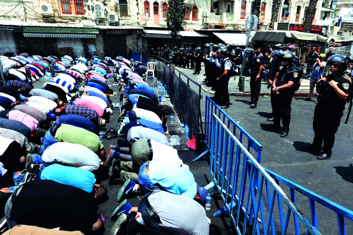 Palestinian pray outside Damascus Gate, yesterday. 
