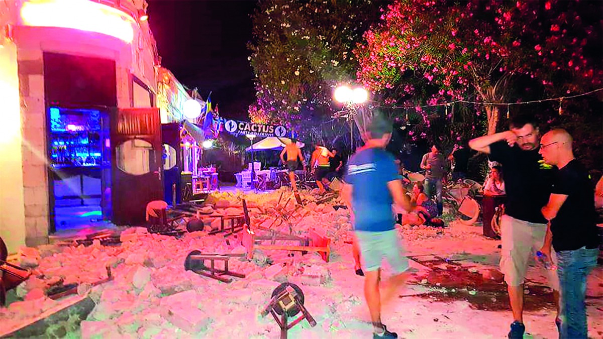 People stand outside damaged buildings after an earthquake in the Greek island of Kos, yesterday.