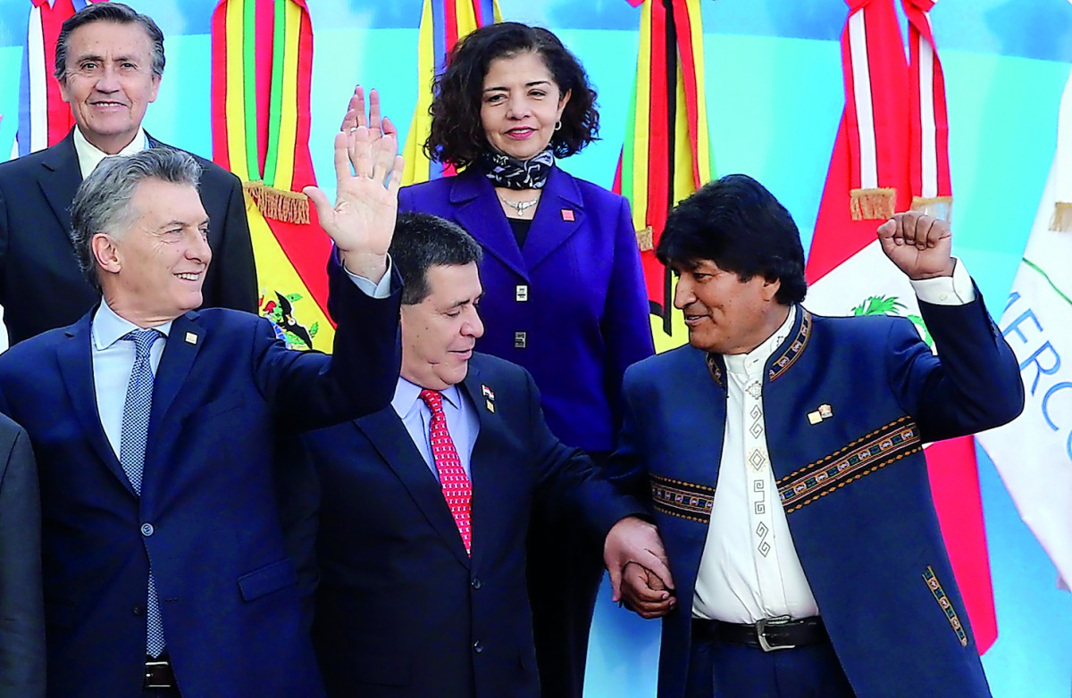 FROM LEFT (front row): Argentina’s President Mauricio Macri, Paraguay’s President Horacio Cartes and Bolivia’s President Evo Morales gesture alongside Ecuador’s head of the delegation Diego Rivadeneira Espinoza and Mexico’s Ambassador in Argentina Mabel G
