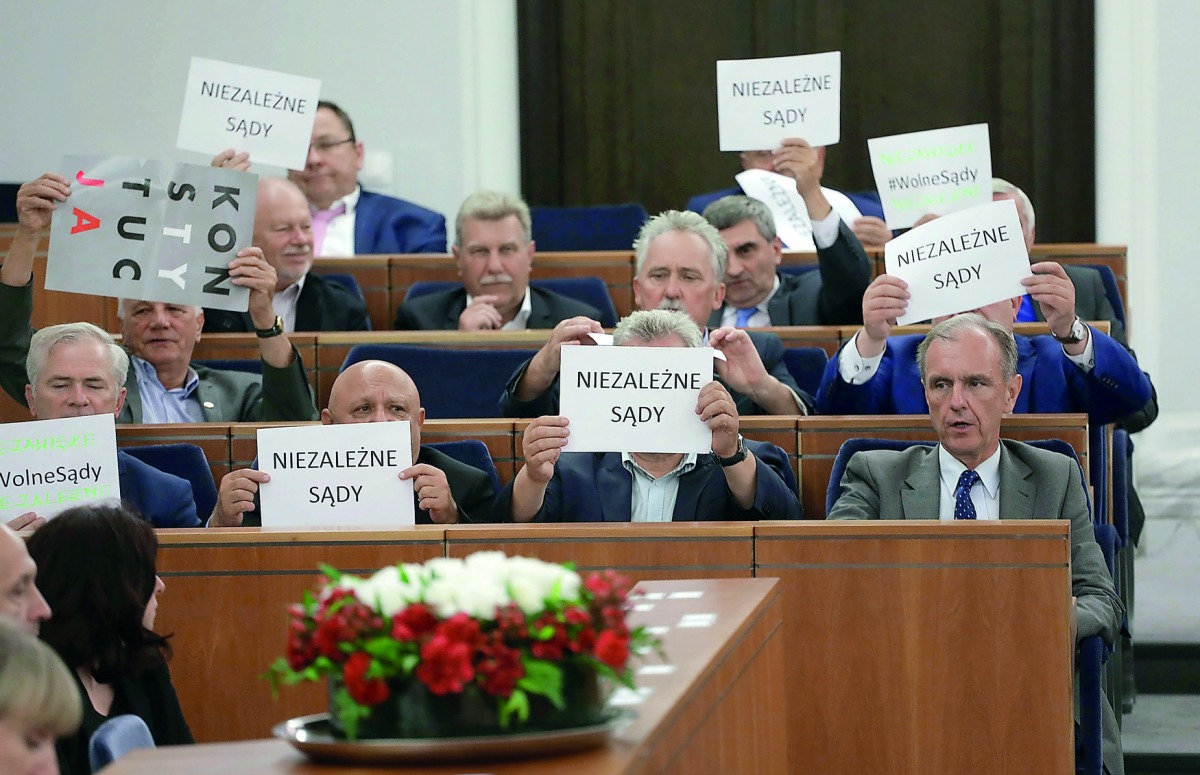 Opposition senators hold papers that read 'Independent Courts
