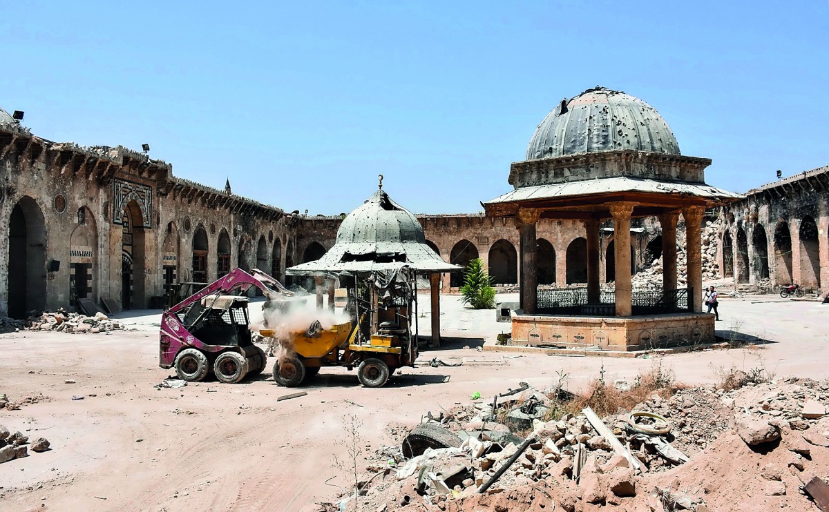 Workers clearing rubble from the courtyard of the ancient Great Umayyad Mosque in the old city, yesterday.
