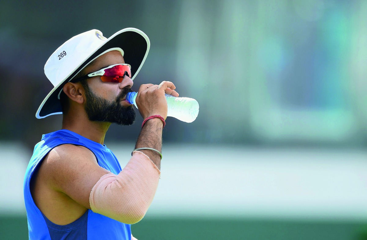 Indian cricket team captain Virat Kohli drinks water during a practice session at Galle International Cricket Stadium in Galle yesterday. India will play three Tests, five one-day internationals and a Twenty20 game in Sri Lanka. The first Test starts on J
