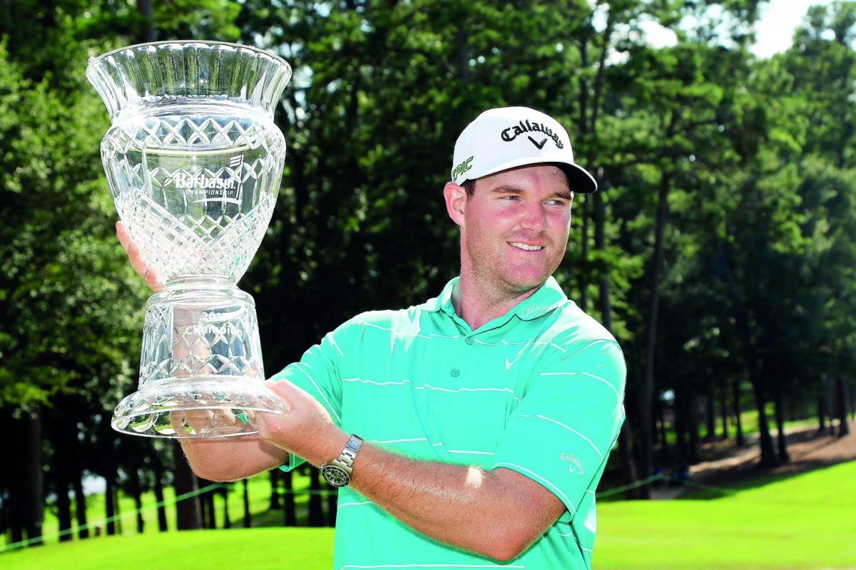 Grayson Murray of the United States celebrates with the trophy after winning on the 18th green during the final round of the Barbasol Championship at the Robert Trent Jones Golf Trail at Grand National on Sunday in Auburn, Alabama.