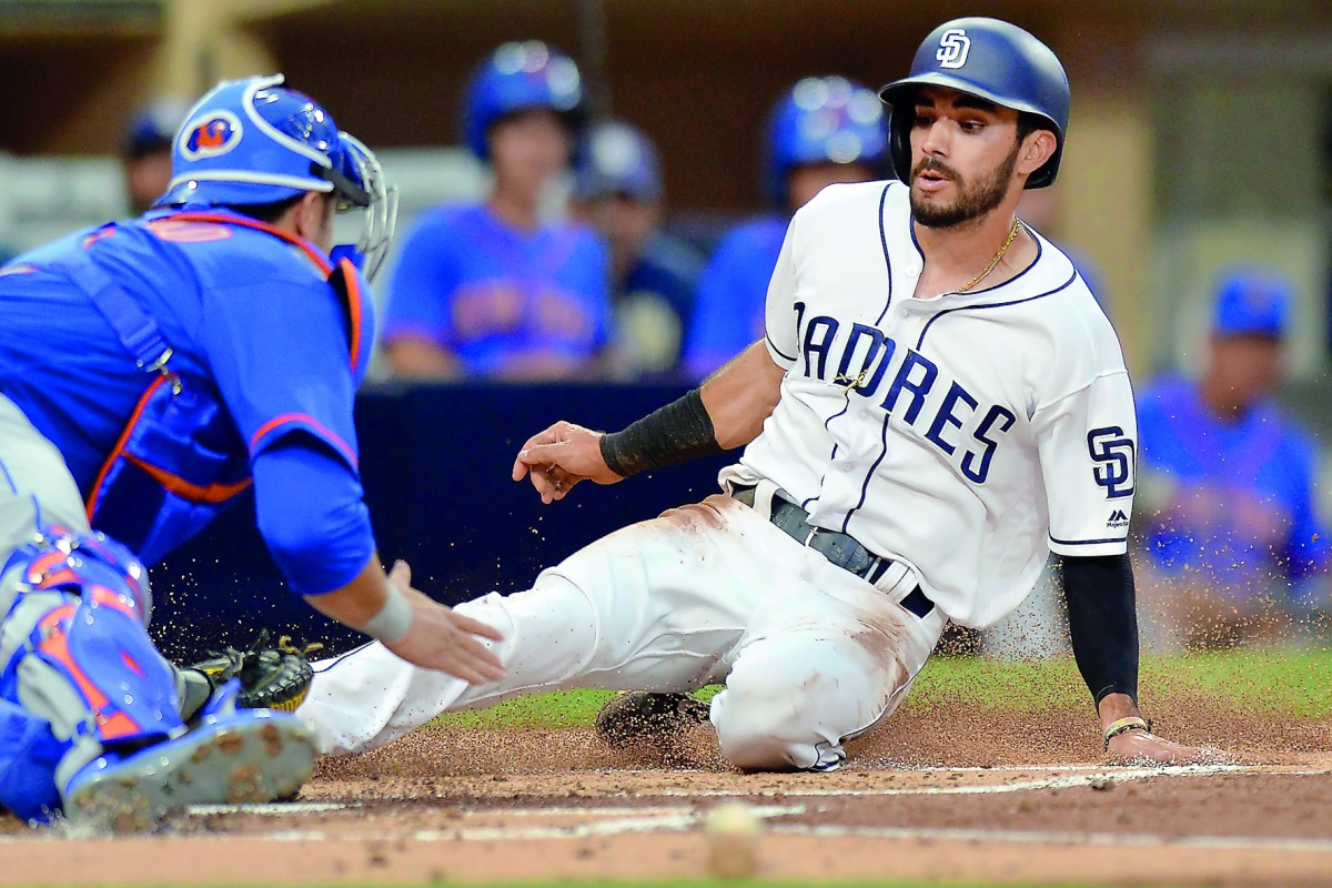 San Diego Padres second baseman Carlos Asuaje (right) is tagged out at home by New York Mets catcher Travis d’Arnaud during the first inning of their MLB game at Petco Park in San Diego on Tuesday.