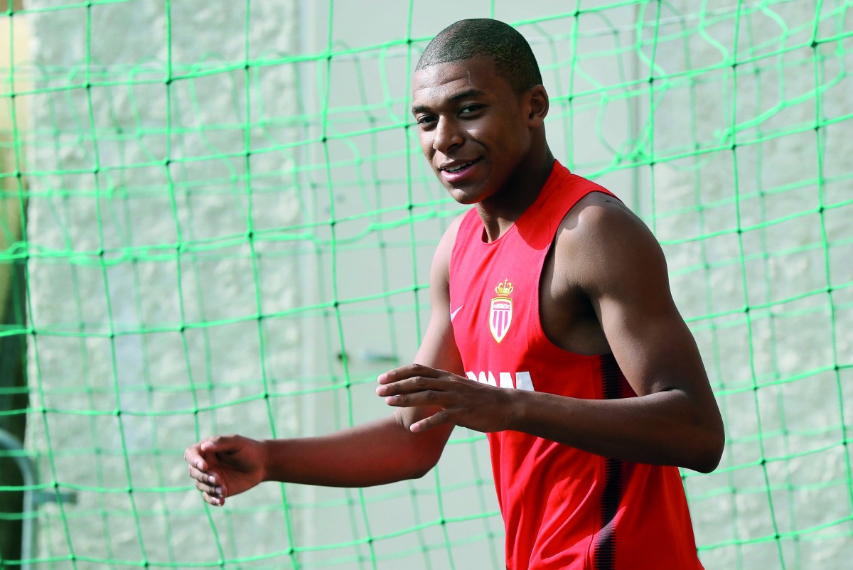 This file photo taken on July 10, 2017 shows Monaco’s French forward Kylian Mbappe arriving for a training session in La Turbie near Monaco.