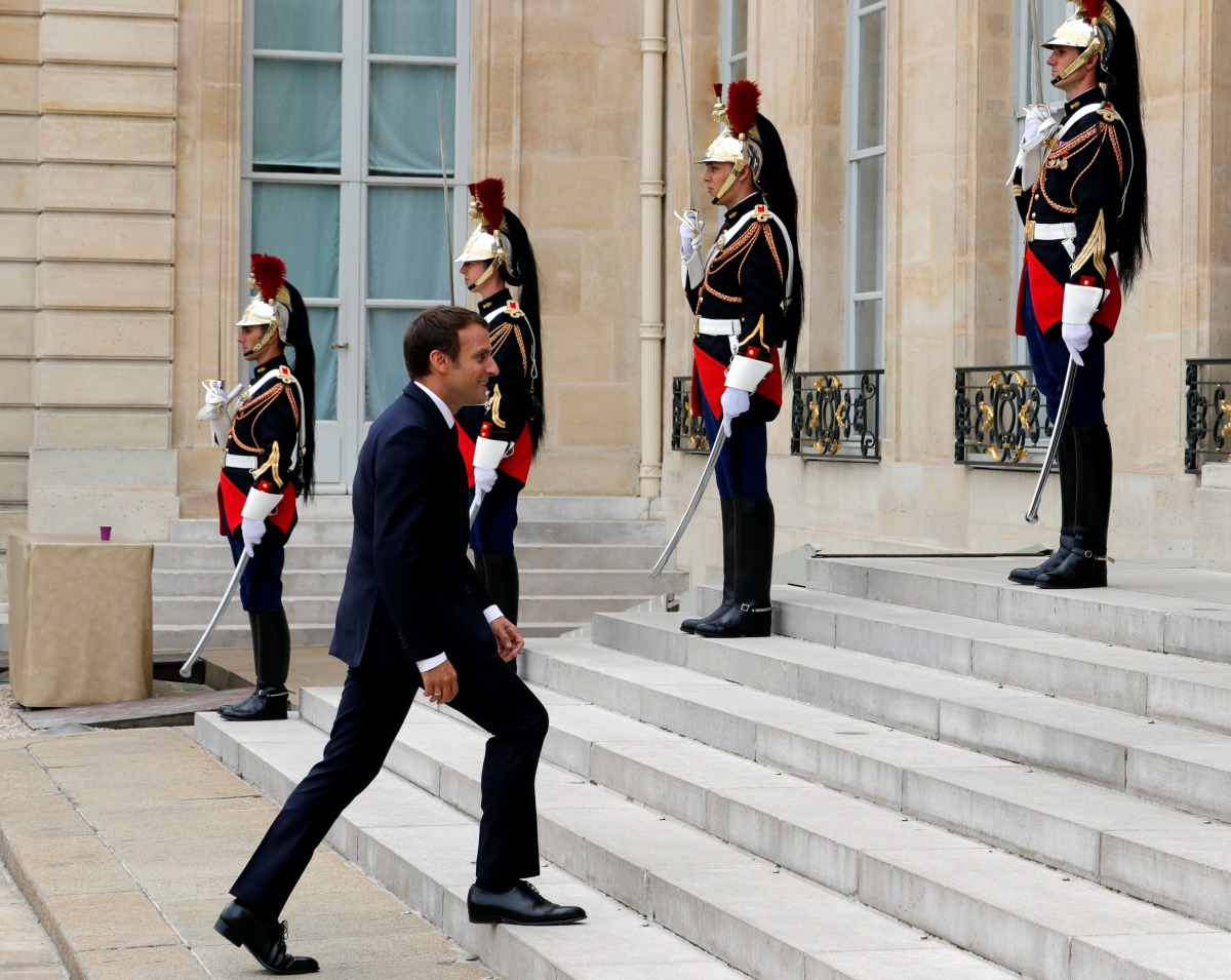 French President Emmanuel Macron walks after a meeting at the Elysee Palace in Paris, France, July 28, 2017. REUTERS/Philippe Wojazer