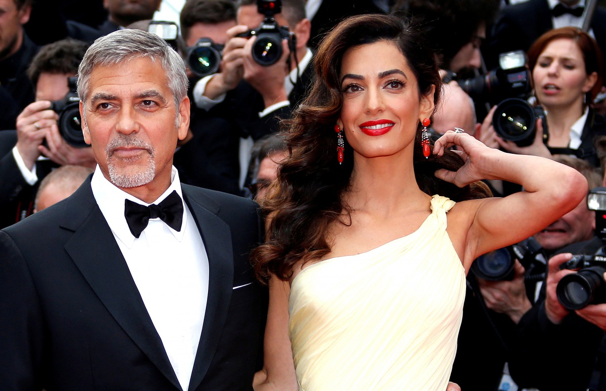 George Clooney and his wife Amal pose on the red carpet as they arrive for the screening of the film 