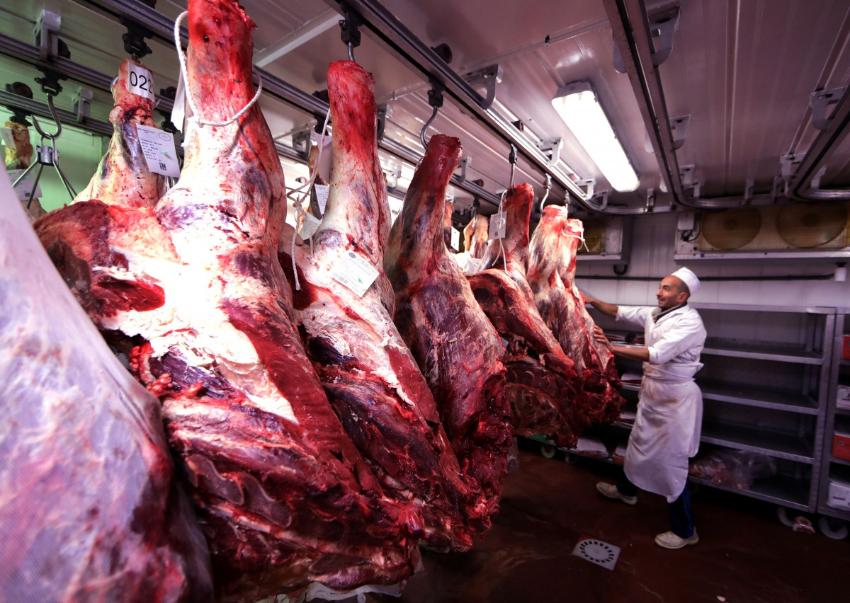 A butcher checks carcasses of beef in a meat refrigerator at the Boucherie St Francois butcher shop in the old city of Nice, France July 28, 2017. Reuters/Eric Gaillard