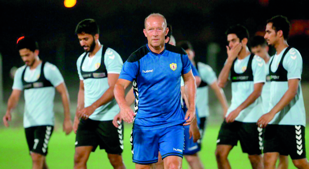 Qatar SC coach Gabriel Calderon leads his team during a training session in Doha.