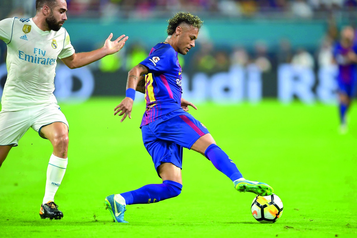 Neymar of Barcelona vies for the ball with Daniel Carvajal of Real Madrid during their International Champions Cup football match at Hard Rock Stadium in Miami, Florida.
