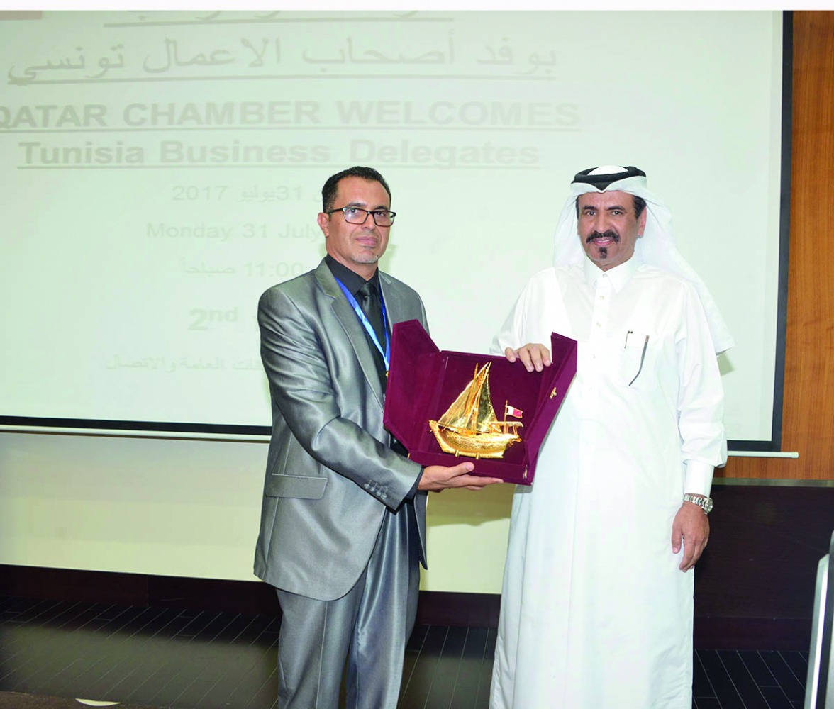 Mohamed bin Ahmed bin Tawar Al Kuwari, QC vice-president, honouring the head of the Tunisian trade delegation at QC headquarters, yesterday. 