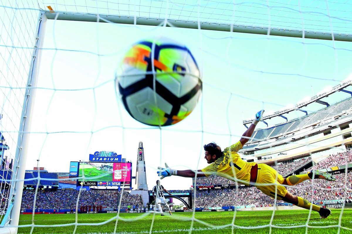 Douglas Costa of Juventus scores during the penalty shootout against Roma during the International Champions Cup 2017 match at Gillette Stadium on Sunday in Foxboro, Massachusetts. Juventus defeat Roma 6-5 in penalties.