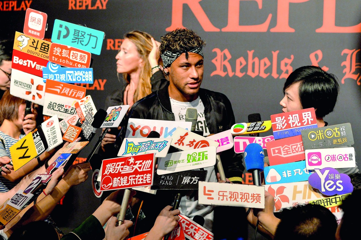 Brazilian football star Neymar Jr. looks on as he speaks to media at a fashion event in Shanghai yesterday. Neymar hit the red carpet in Shanghai yesterday as speculation mounted that the Brazil star could be set to quit Barcelona for Paris Saint-Germain 