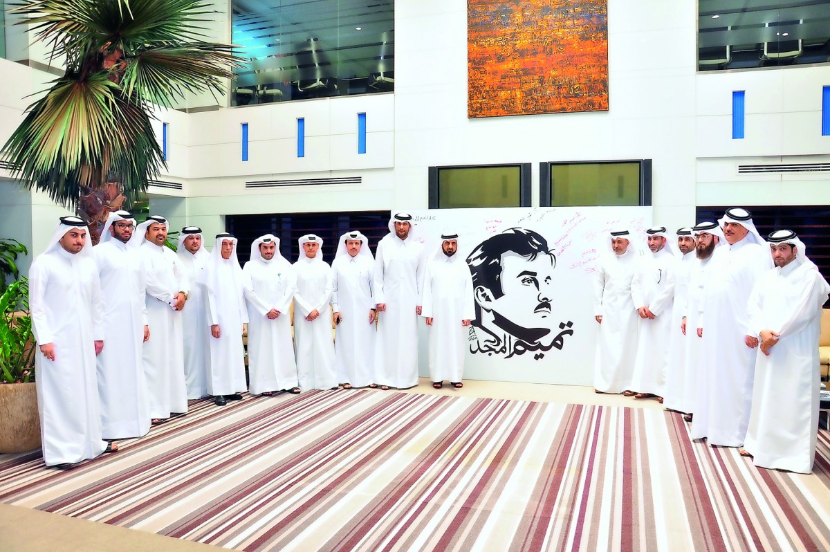 The chairman of QIB, Sheikh Jassim bin Hamad bin Jassim bin Jaber Al Thani (ninth from left),  members of the Board of Directors, and other senior officials of the Bank after the signing at QIB’s headquarters in Grand Hamad Street, yesterday.  
