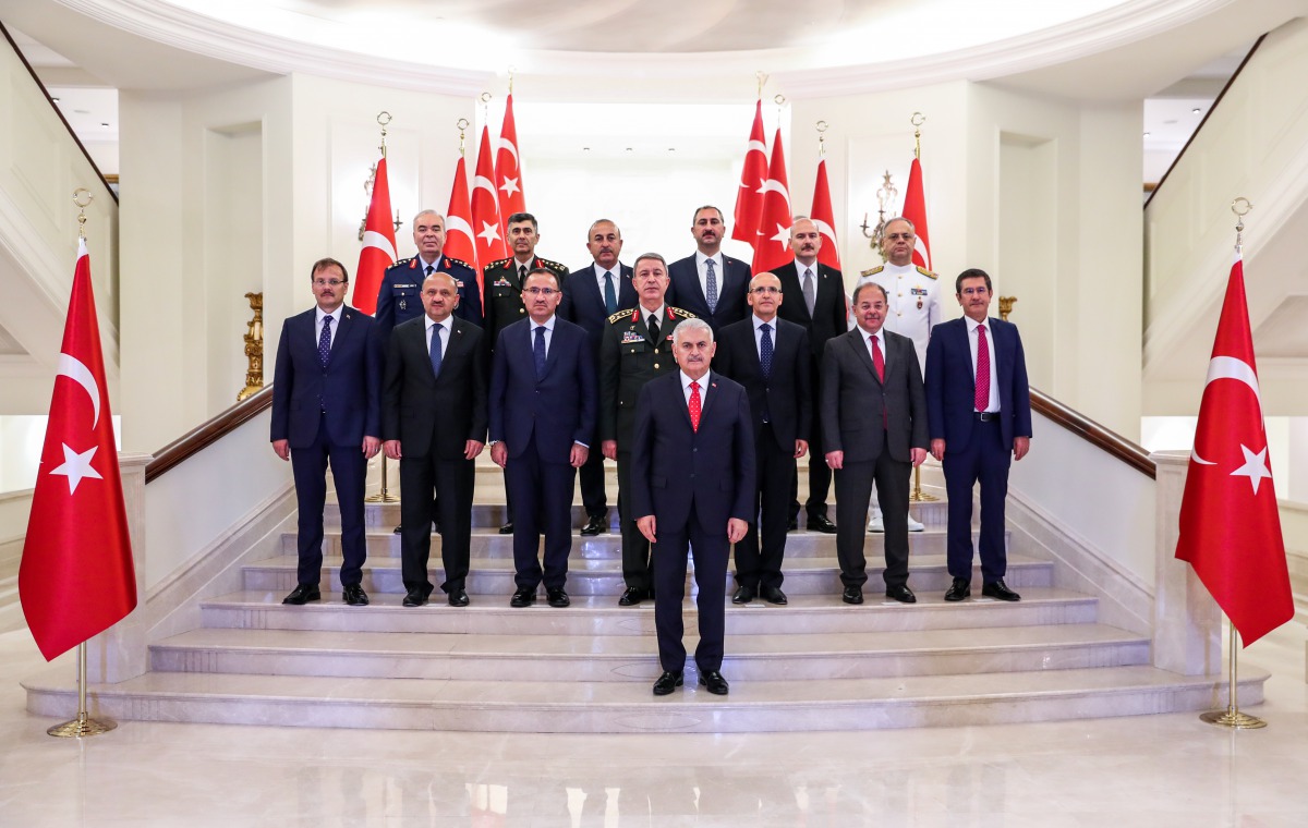 Turkish Supreme Military Council (YAS) members, Turkey's Prime Minister Binali Yildirim (C); (Front row L to R) Turkish Deputy Prime Ministers Hakan Cavusoglu, Fikri Isik, Bekir Bozdag, Turkish Military Chief of Staff General Hulusi Akar, Turkish Deputy P