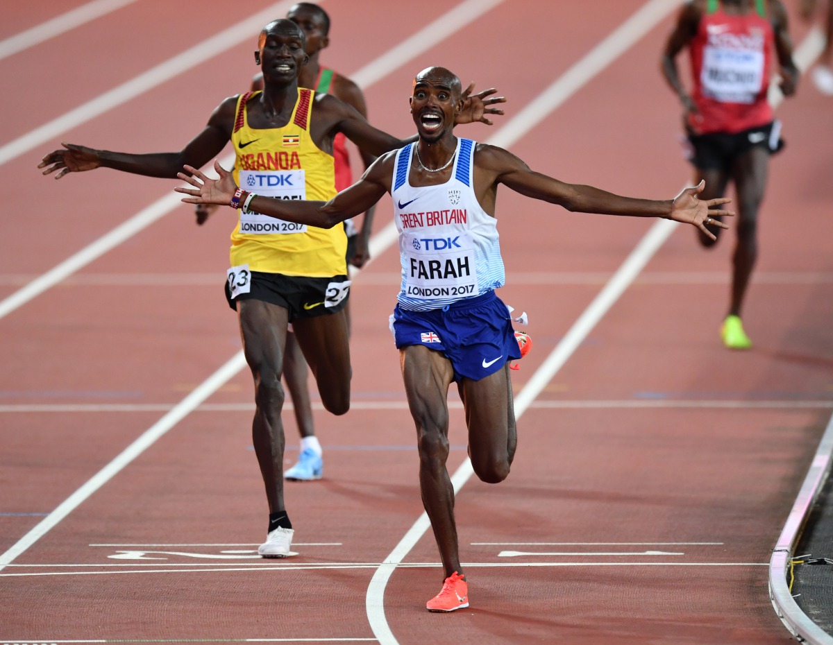 Winner Mo Farah (R) of Great Britain and runner up Joshua Kiprui Cheptegei (23) of Uganda celebrate after the men's 10,000 meters during the 