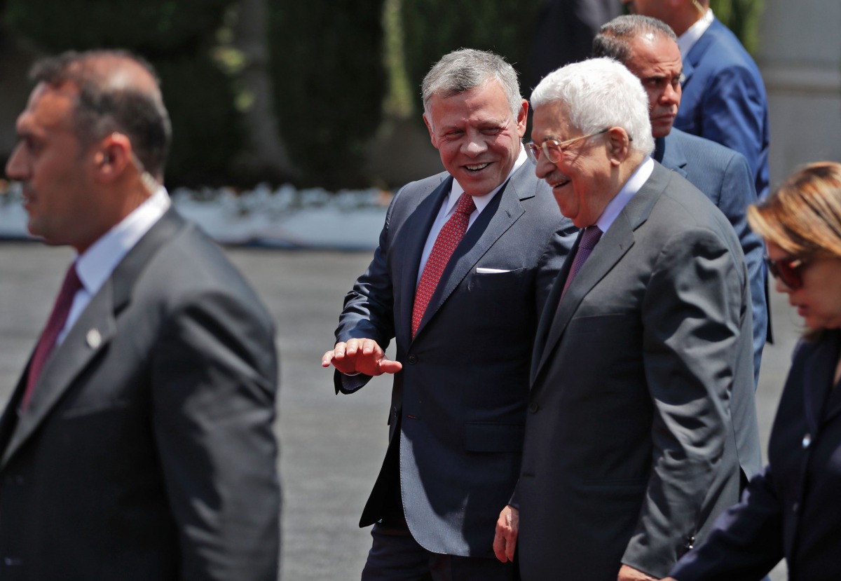 Jordan's King Abdullah II (C) speaks with Palestinian president Mahmud Abbas (2nd-R) upon his arrival in the West Bank city of Ramallah on August 7, 2017. Jordan's King began a rare visit to the occupied West Bank to meet with Palestinain president, amid 