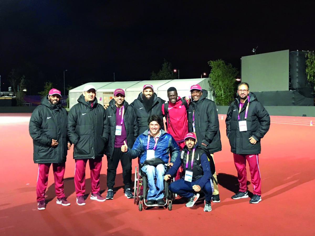 Officials of the Qatari delegation pose for a picture with young sprinter Abdalelah Haroun who won the bronze medal in the men’s 400 metres event at the IAAF Athletics World Championships in London on Tuesday. Haroun made history by becoming Asia’s first 