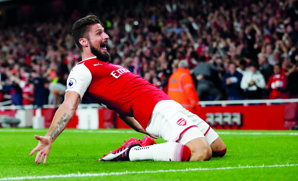 Arsenal’s Olivier Giroud celebrates after scoring their fourth goal against Leicester City in the opening match of English Premier League Premier League in London yesterday.