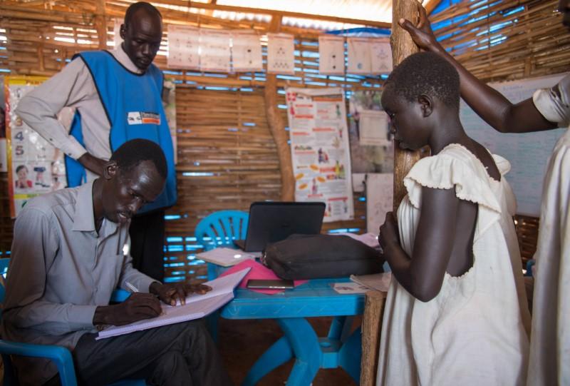 Sandy makes sure she is registered at the child friendly space, where she can play and receive psychosocial support in Juba, South Sudan on July 28, 2017. Thomson Reuters Foundation/Stefanie Glinski