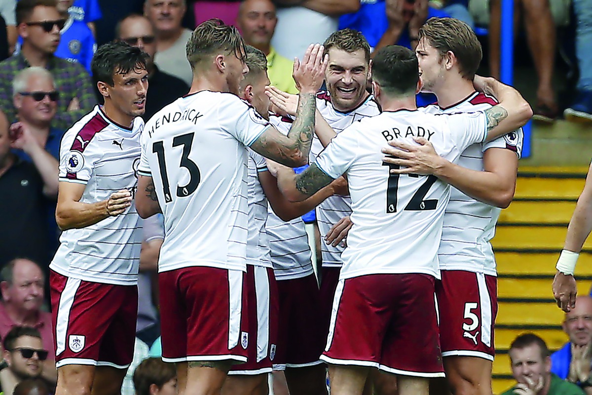 Burnley’s Welsh striker Sam Vokes (centre) celebrates with team-mates after scoring the opening goal of their Premier League game against Chelsea in London yesterday. 