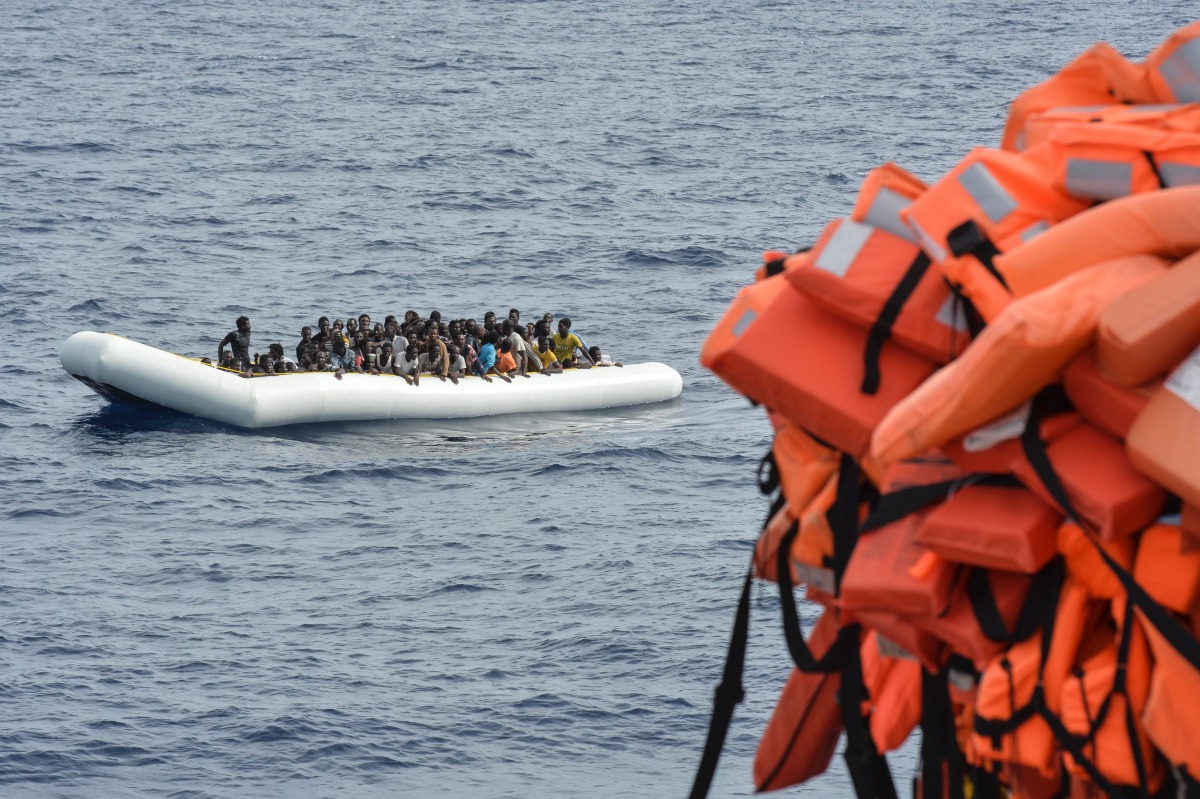 Migrants on a rubber boat waiting to be evacuated during a rescue operation by the crew of the Topaz Responder on November 5, 2016 off the coast of Libya. (AFP/Andreas Solaro)