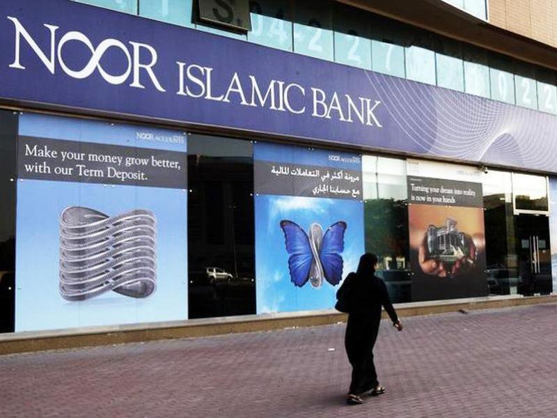 A woman walks past a branch of Noor Islamic Bank in Dubai. (Reuters / File photo)
