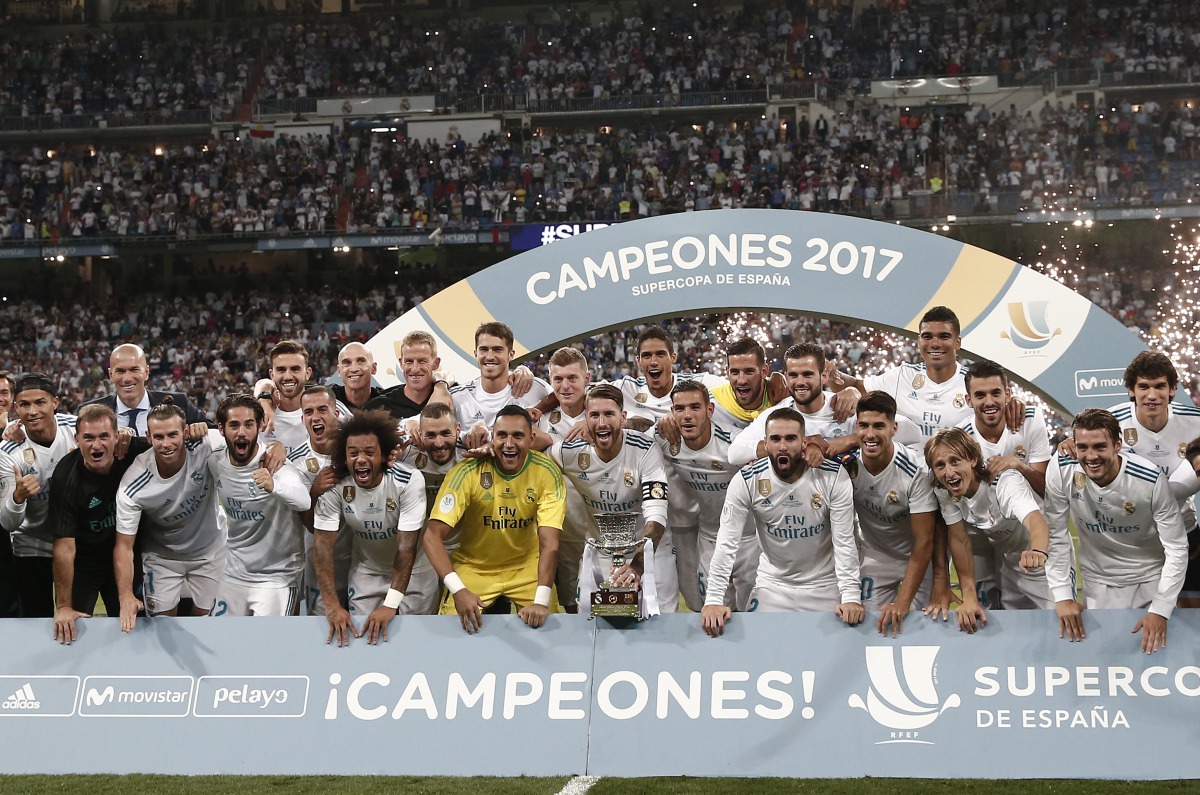 Players and the technical team of Real Madrid pose for a photo as they celebrate winning the Spanish Super Cup in the return match against Barcelona at Santiago Bernabeu Stadium in Madrid, Spain on August 17, 2017. (Burak Akbulut - Anadolu Agency)