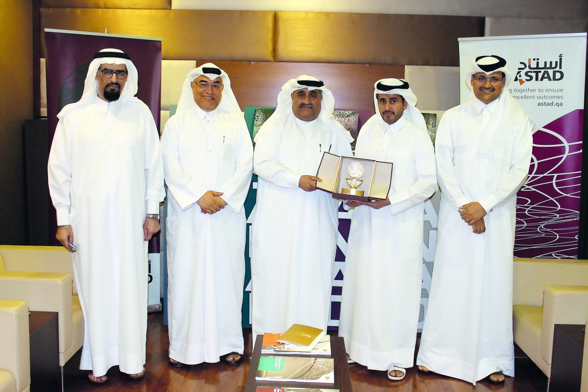 ASTAD and QSE officials exchanging memento during their meeting.