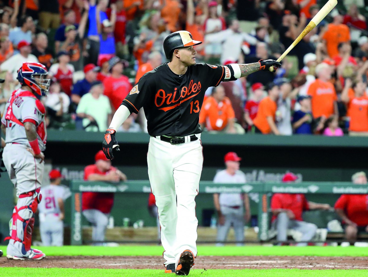Baltimore Orioles third baseman Manny Machado (right) connects on a grand slam home run in the bottom of the 9th inning to win the game against the Los Angeles Angels in Baltimore on Friday.