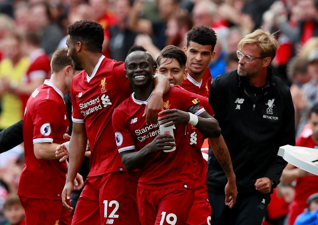 Liverpool's Sadio Mane (C) celebrates scoring their first goal with Liverpool manager Juergen Klopp and team mates Action Images via Reuters/Jason Cairnduff  
