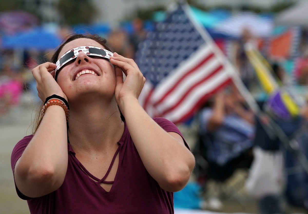 People watch the first solar eclipse to sweep across the United States in over 99 years on the beach August 21, 2017 on Hilton Head Island, South Carolina. Millions of people are expected to watch as the eclipse cuts a path of totality 70 miles wide acros