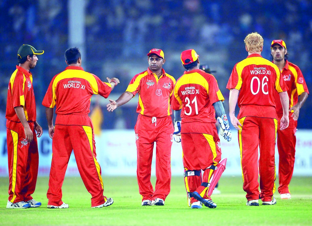 International World XI players celebrating the dismissal of Pakistan All Stars batsman Shoaib Malik during the second Twenty 20 cricket match at the National Stadium in Karachi in this October 21, 2012 file photo. Pakistan yesterday announced the return o