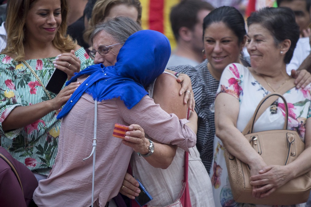BARCELONA, SPAIN - AUGUST 21: Two women hug as they mourn during a demonstration against terror attacks and solidarity with the victims of the terror attack in Barcelona, Spain on August 21, 2017. ( Albert Llop - Anadolu Agency ).