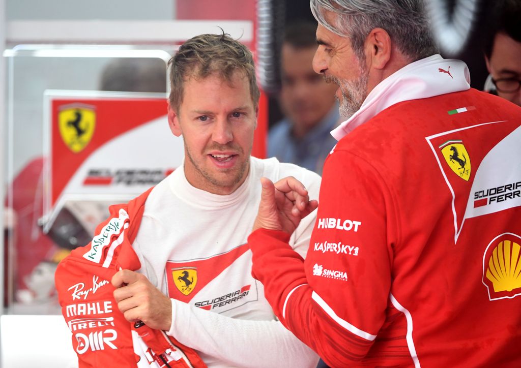 Ferrari's German driver Sebastian Vettel speaks with team principal of the Ferrari Formula One team Maurizio Arrivabene (R) during the second practice session at the Spa-Francorchamps circuit in Spa on August 25, 2017 ahead of the Belgian Formula One Gran