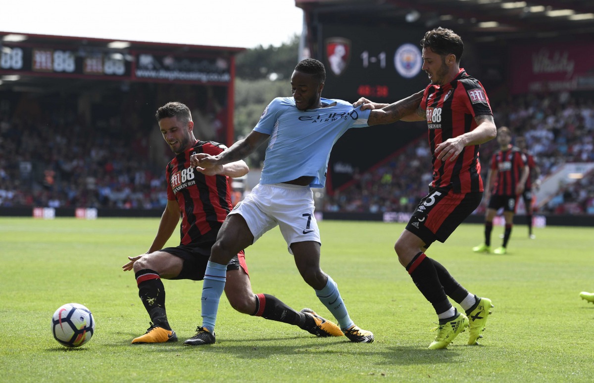 Manchester City's Raheem Sterling in action with Bournemouth's Adam Smith and Andrew Surman . REUTERS/Tony O'Brien