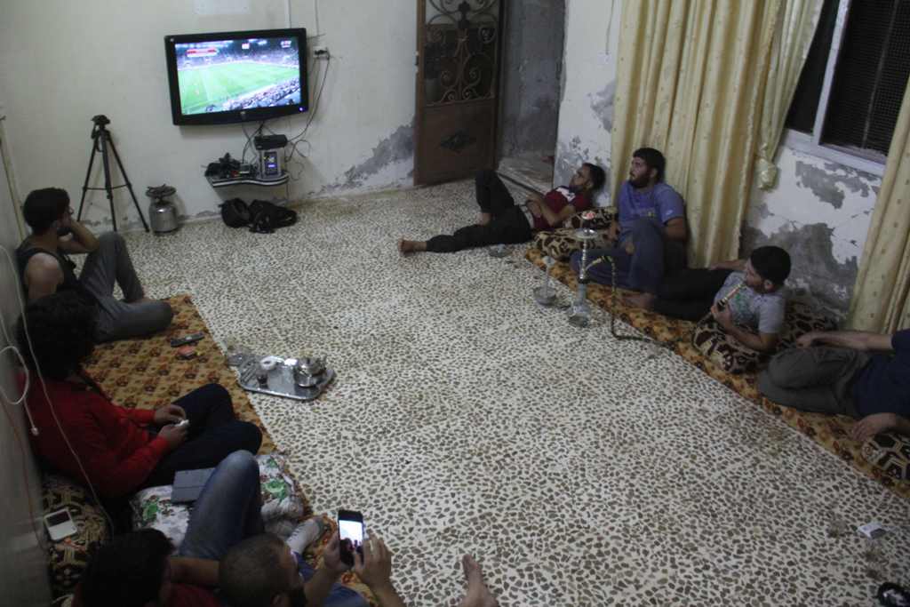 Syrian football fans watch the Portugal vs Hungary World Cup qualifier football match at a friend's house in Binnish on the outskirts of Idlib on September 3, 2017.  AFP / OMAR HAJ KADOUR
