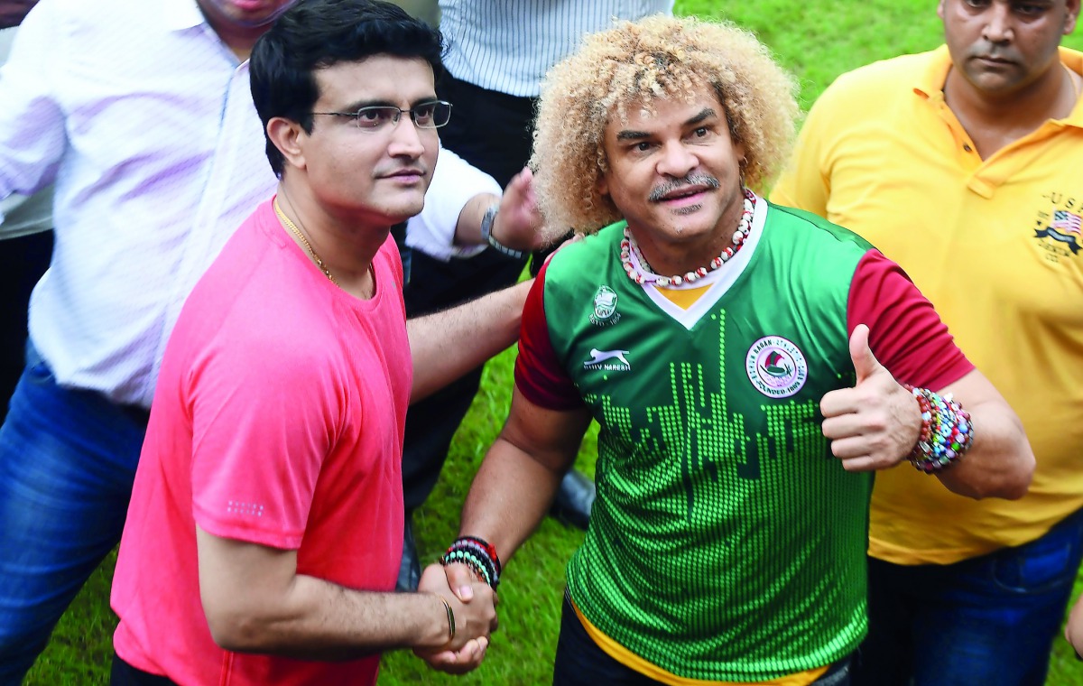 Former Colombian footballer Carlos Valderrama (right), who played in three World Cup tournaments, poses for pictures with former Indian cricket captain Sourabh Ganguly during an event ahead of the FIFA U-17 World Cup tournament in India, in Kolkata yester
