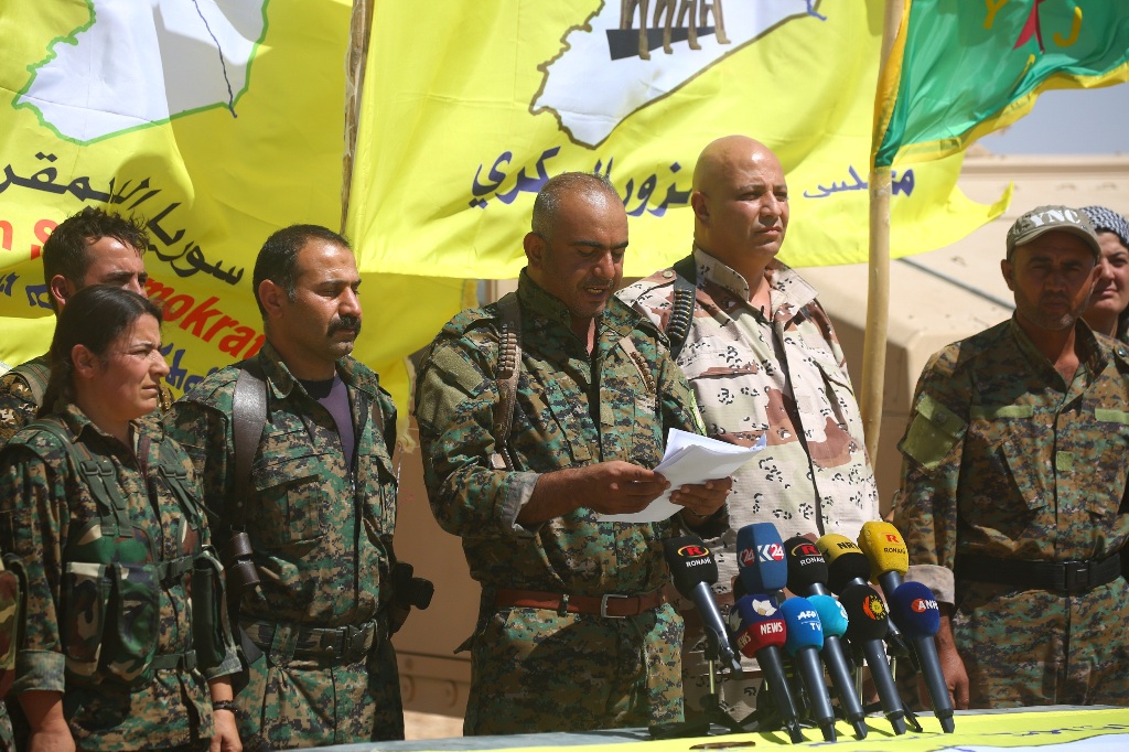 Ahmad Abu Khawlah (3rd-R), chief of the Deir Ezzor Military Council (DEMC) -- a coalition of Arab tribes and fighters that belongs to the broader US-backed Syrian Democratic Forces -- speaks during a press conference in the northeastern Syrian village of 