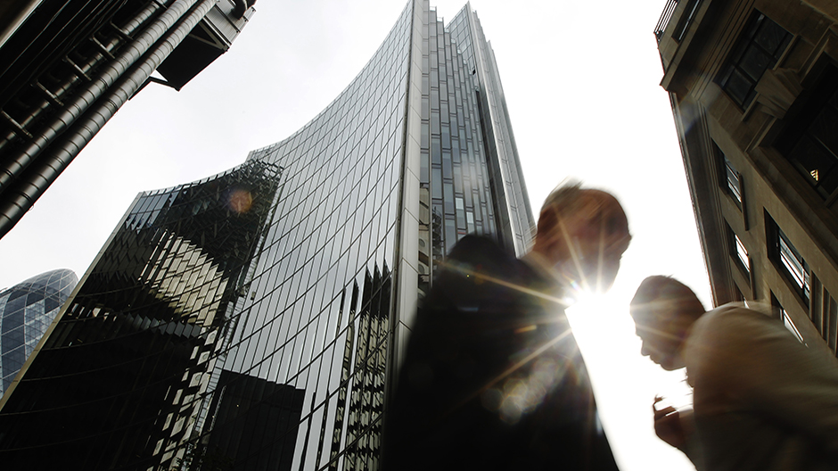 Pedestrians pass office blocks in the City of London June 19, 2013. Reuters/Luke MacGregor