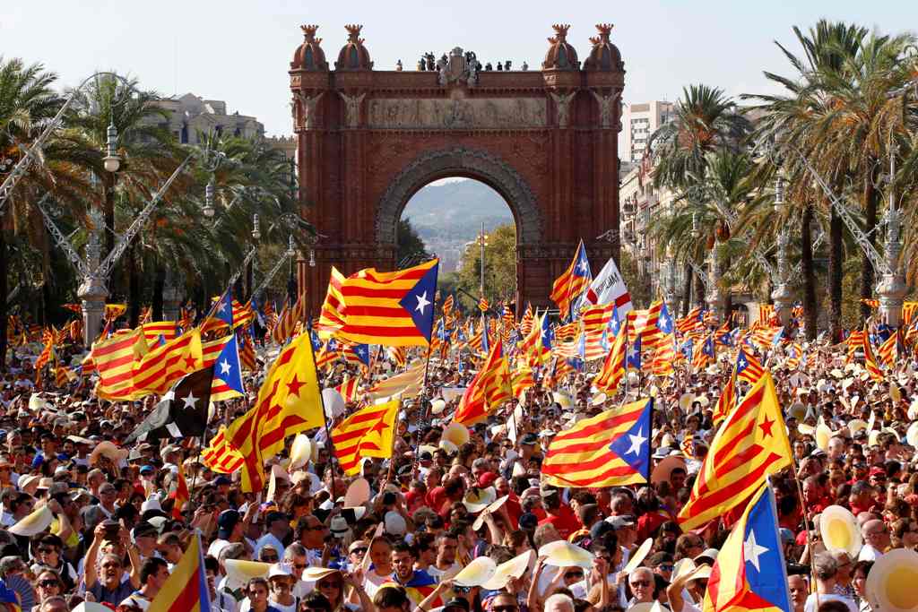 (FILES) This file photo taken on September 11, 2016 shows people waving 'Esteladas' (pro-independence Catalan flags) as they gather during a pro-independence demonstration, in Barcelona during the National Day of Catalonia 'Diada'.  AFP / PAU BARRENA
