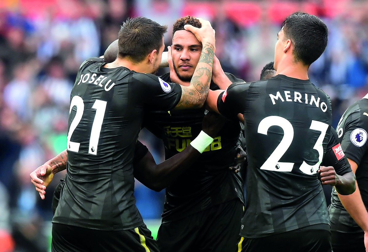 Newcastle United’s Jamaal Lascelles (centre) celebrates his goal with team-mates during the Premier League match against Swansea City in Swansea, yesterday.