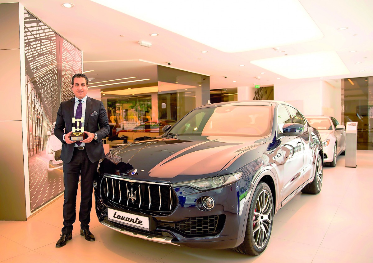 A senior official of the Maserati Qatar, Alfardan Sports Motors, posing with the award.