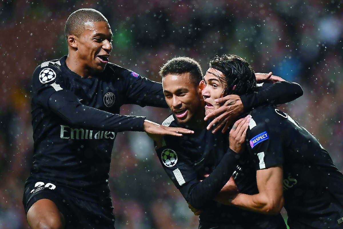 PSG’s Brazilian striker Neymar (centre) celebrates with French striker Kylian Mbappe (left) and Uruguayan striker Edinson Cavani after scoring the opening goal of the match on Tuesday.