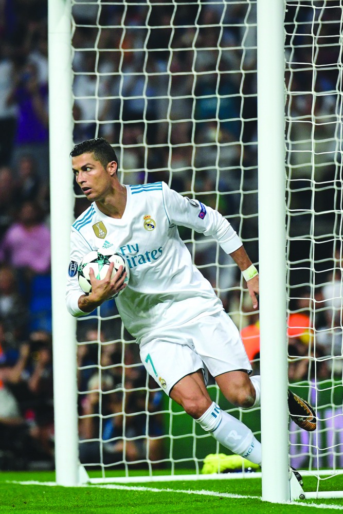 Real Madrid's Portugese forward Cristiano Ronaldo celebrates after scoring during the UEFA Champions League football match against APOEL FC at the Santiago Bernabeu Stadium in Madrid yesterday. Title holders Real won 3-0.