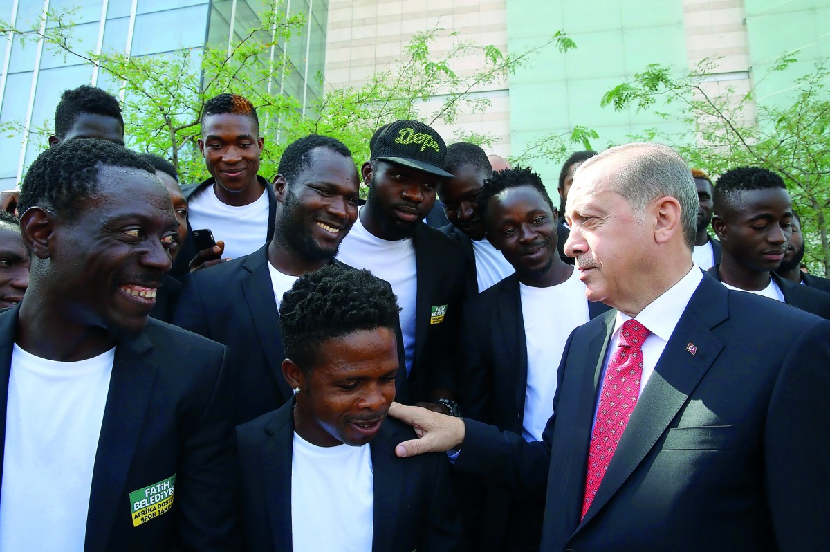President of Turkey, Recep Tayyip Erdogan (right), talks to players of Istanbul Fatih Municipality African Friendship Sports Team after attending the Mayors Consultation and Evaluation Meeting at ATO Congresium in Ankara, yesterday.