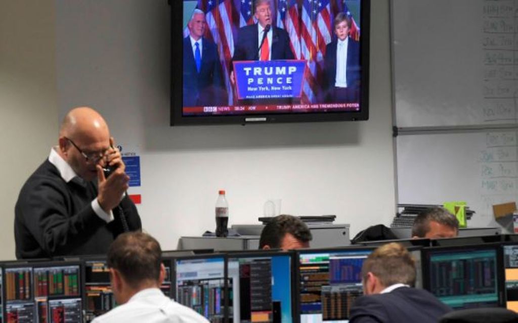 Traders at BGC Partners look at screens as victorious US Presidential election candidate Donald Trump speaks CREDIT: TOBY MELVILLE/REUTERS.